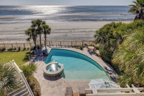 Relax by the pool surrounded by palm trees and enjoy the tranquil ocean view.