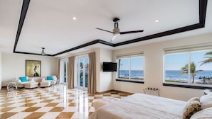 A hotel room with a checkered floor, a bed, a TV, and a view of the ocean. - Luxury Beach House for Families - Private Pool, Rooftop & Ocean Views (Fort Lauderdale)