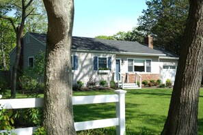 A single-story house with a front porch, a garage, and a well-maintained lawn. - Summer in the Hamptons (Westhampton Beach)