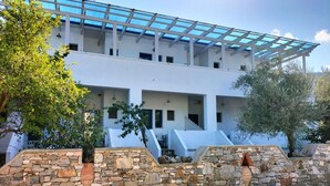 Un bâtiment moderne doté d’un toit en verre, de murs en pierre et d’un escalier menant à un niveau supérieur.