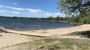 A sandy beach with a wooden dock extending into a calm lake. - Stately home by Spirit Lake in Menahga (Menahga)