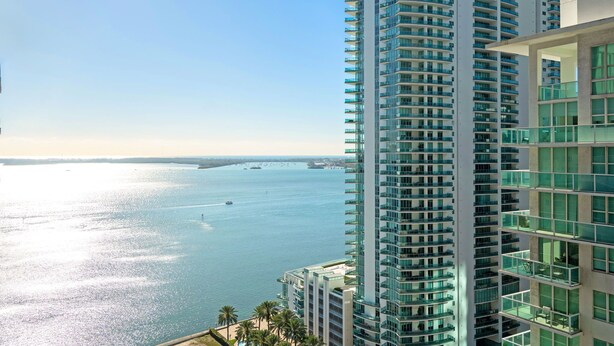 A high-rise building with a view of a body of water and distant land. - Fabulous Two Bedrooms Brickell+ Free Parking (Miami)
