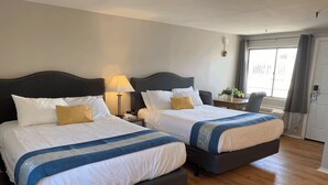 A hotel room with two beds, a desk, a chair, and a window with curtains. - Ways Motel (Hampton)