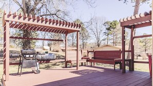 A wooden deck with a grill and benches. - 2 Bedroom Home less than 2 miles to Jacks Fork River (Eminence)