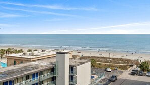 A hotel with a rooftop pool overlooking a beach. - Ocean Pearl: 7 BR Oceanfront Condo (Myrtle Beach)