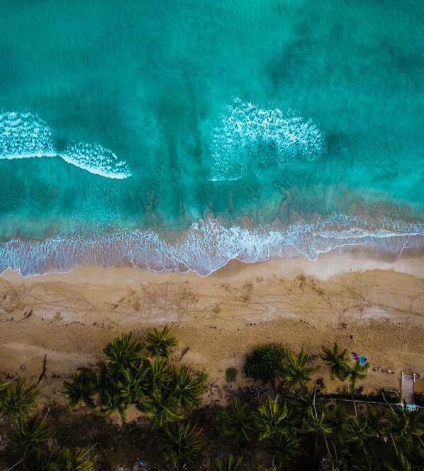 On the beach, white sand, sun loungers, beach towels