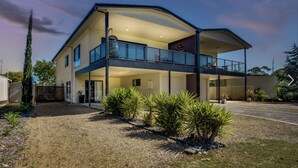 A modern two-story house with a balcony, large windows, and a well-maintained lawn. - Goolwa serenity, Great balcony, Modern, peaceful, water and attractions close by (Goolwa South)