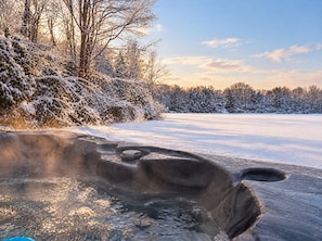 A frozen outdoor area with a hot tub partially submerged in ice. - "The Lure" Delightful, Private Waterfront Getaway (Lake Harmony)