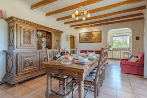 A dining area with a wooden table, chairs, and a cabinet.
