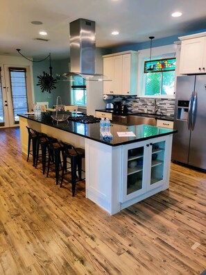 Enjoy cooking in this well-equipped kitchen with a central island and stainless steel appliances.