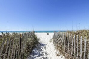 A sandy beach path leading to the ocean, flanked by wooden fences and tall grasses. - Great Family Adventure 2nd floor 2 bedroom unit, Spring/Summer dates open! (Panama City Beach)