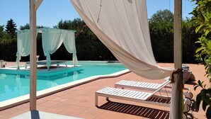 A pool area with a covered seating area and lounge chairs. - Villa Angela | Beautiful Villa with Pool in Puglia in Polignano a Mare, Italy (Polignano a Mare)