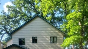 A two-story house with a garage, a covered porch, and a driveway.