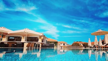 Seasonal outdoor pool, open 11:00 AM to 8:30 PM, pool umbrellas