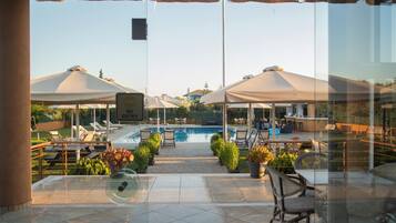Seasonal outdoor pool, open 11:00 AM to 8:30 PM, pool umbrellas