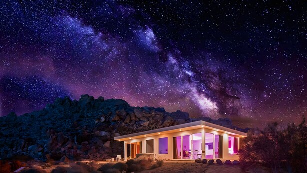 A modern, illuminated building with a clear view of the night sky and Milky Way. - Stars on the Rocks: Pool/HotTub/FirePit/Boulders! (Joshua Tree)