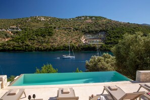 An infinity pool, pool loungers