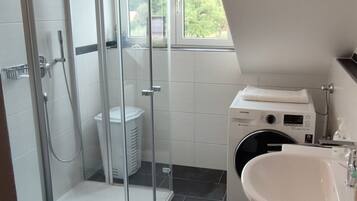 Shower, hair dryer, soap, toilet paper