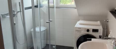 Shower, hair dryer, soap, toilet paper
