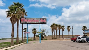 A sign for 'Champions Inn' with a 'VACANCY' sign below it, indicating available rooms.