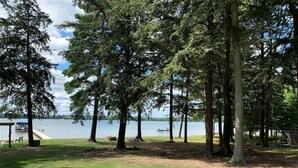 A lakeside park with picnic tables and a dock.