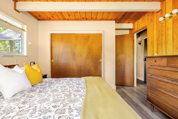 A bedroom with a bed, a wooden wardrobe, a door, and a window. - Spacious Chalet with Game Loft & Pool Access (Arnold)