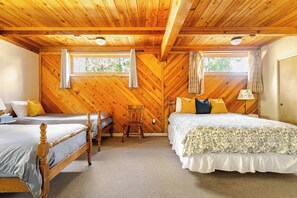 A room with two wooden beds, a chair, and a window. - Spacious Chalet with Game Loft & Pool Access (Arnold)