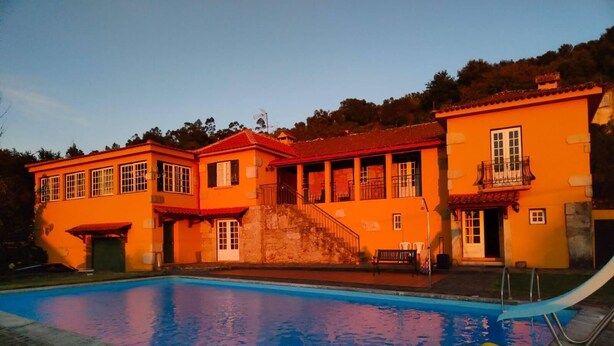 A large house with a swimming pool, a balcony, and a staircase leading to the upper floor. - House with pool and barbecue (Valença)