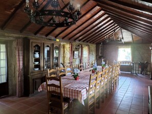 Enjoy meals in this cozy dining area with a long table and comfortable seating.