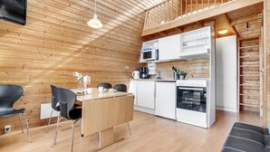 A modern kitchen with white cabinets, a microwave, and a built-in oven. - Beautiful home in Fredericia with WiFi (Fredericia)