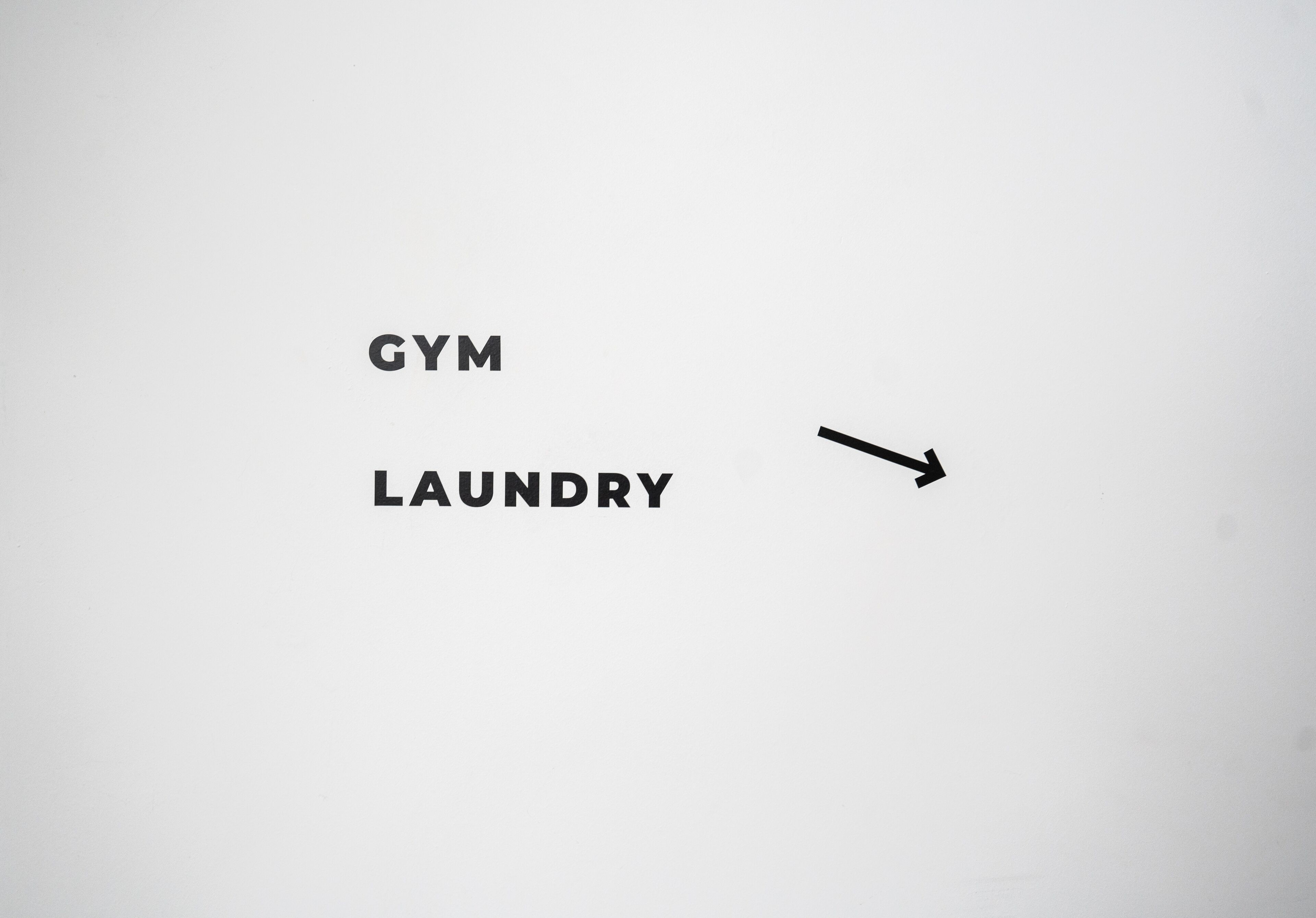 The words "GYM" and "LAUNDRY" with an arrow pointing from "GYM" to "LAUNDRY".