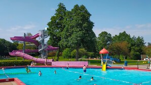 A swimming pool with multiple lanes, a water slide, and a playground area. - Nice home in Heinkenszand with sauna (Heinkenszand)