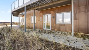A modern building with a flat roof, large windows, and a covered walkway. - Awesome apartment in Ringkøbing (Ringkøbing)
