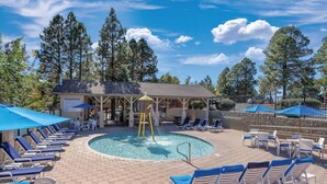 A pool area with lounge chairs, a covered seating area, and a water feature. - Price REDUCED  2Bed 2Bath, Full Kitchen & dining area, Washer/Dryer. Golf nearby (Flagstaff)
