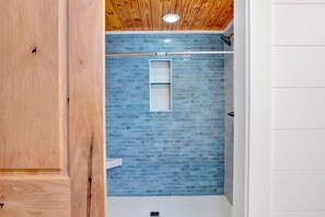 Bathtub, hair dryer, towels, toilet paper