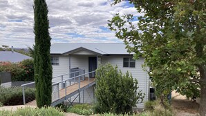 A two-story building with a balcony and a staircase leading to the entrance. - Views, space and tranquility with bay and beach close by (Encounter Bay)