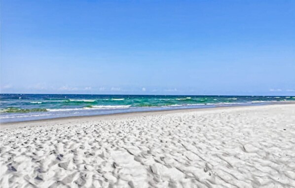 Guests can enjoy access to the beach with white sand and calm ocean views.