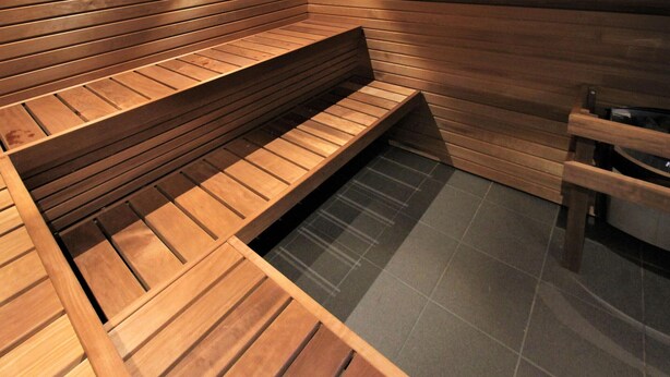 A sauna with wooden benches and a tiled floor. - Stunning home in Grimslöv with sauna (Grimslöv)