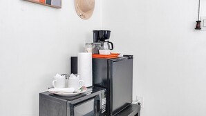 A kitchenette with a microwave, coffee maker, and storage jars. - Little Havana Studio for 4 • Free Parking (Miami)