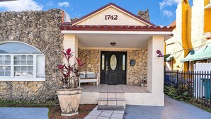A house with a stone facade, a black door, and the number 1742 on the roof. - Little Havana Studio for 4 • Free Parking (Miami)
