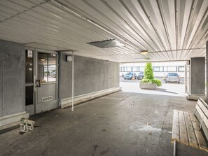 A parking garage with concrete walls, a metal roof, and a bench. - Helsinki rooftop by Interhome (Helsinki)