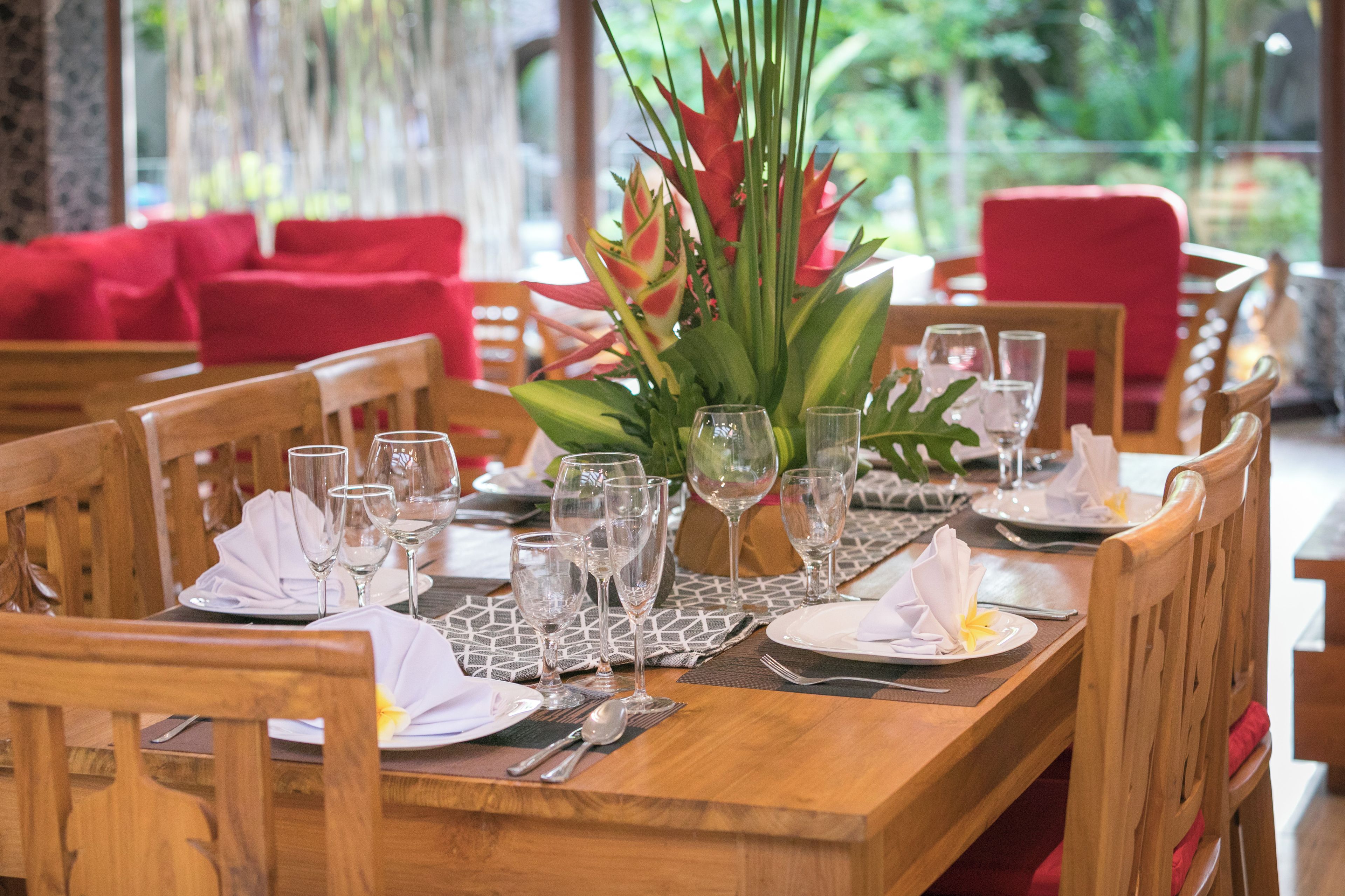 A dining table set with chairs, a centerpiece, and tableware.