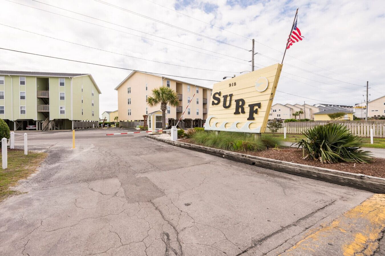 A building with a 'SURF' sign and an American flag, indicating a beach-themed establishment.
