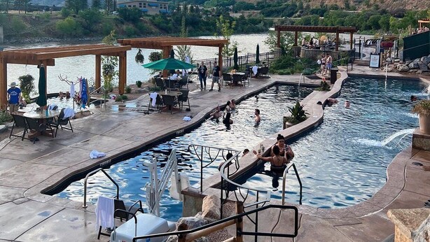 A pool area with a view of mountains, outdoor seating, and a covered area. - Mountain View Hideaway, 14 Min to Glenwood Hot Springs, 2 King Beds, Golf Views (New castle)