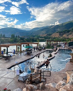 A pool area with a view of mountains, outdoor seating, and a covered area. - Mountain View Hideaway, 14 Min to Glenwood Hot Springs, 2 King Beds, Golf Views (New castle)