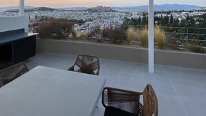 An outdoor patio with a view of a cityscape and mountains. - Acropolis Residence with 360-Degree Athens City Views Rooftop (Athina)