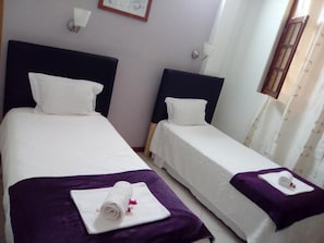 Two single beds with headboards, white linens, and purple bedspreads. - Room-hotel Ah Maio - Double or Twin 1 (Maio)