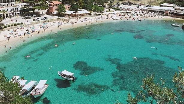 A coastal town with a beach, boats, and mountainous backdrop. - Summer Desire - One Bedroom Apartment With Sea View (Corfu)