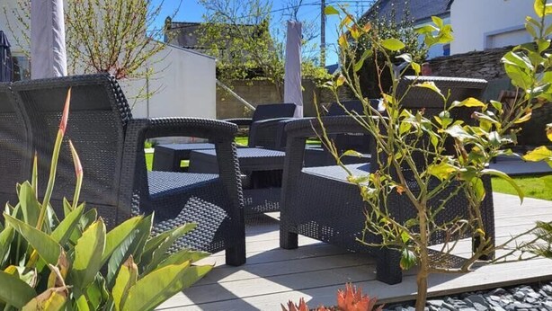An outdoor patio with wicker furniture and a small garden area. - House fig trees Roch Priol (Quiberon)