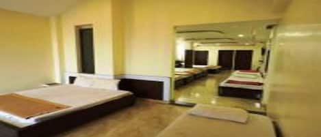 Habitación de hotel con cama, escritorio y silla. Cuenta con ventana y puerta.